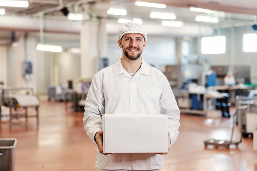 Portrait,Of,A,Meat,Factory,Worker,Holding,Box,With,Fresh