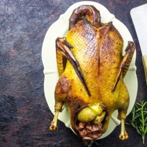 Roast,Duck,With,Apples,And,Oranges,On,Black,Background.,Cooking